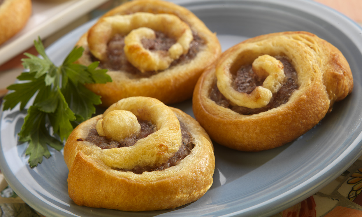 3 hearty sausage crescent rolls on a plate