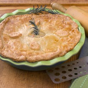 easy chicken pot pie garnished with a sprig of rosemary