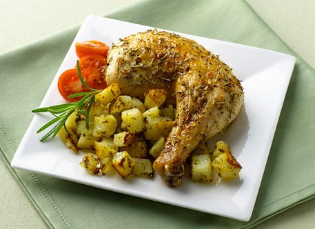 A roasted chicken leg quarter with pesto potato casserole