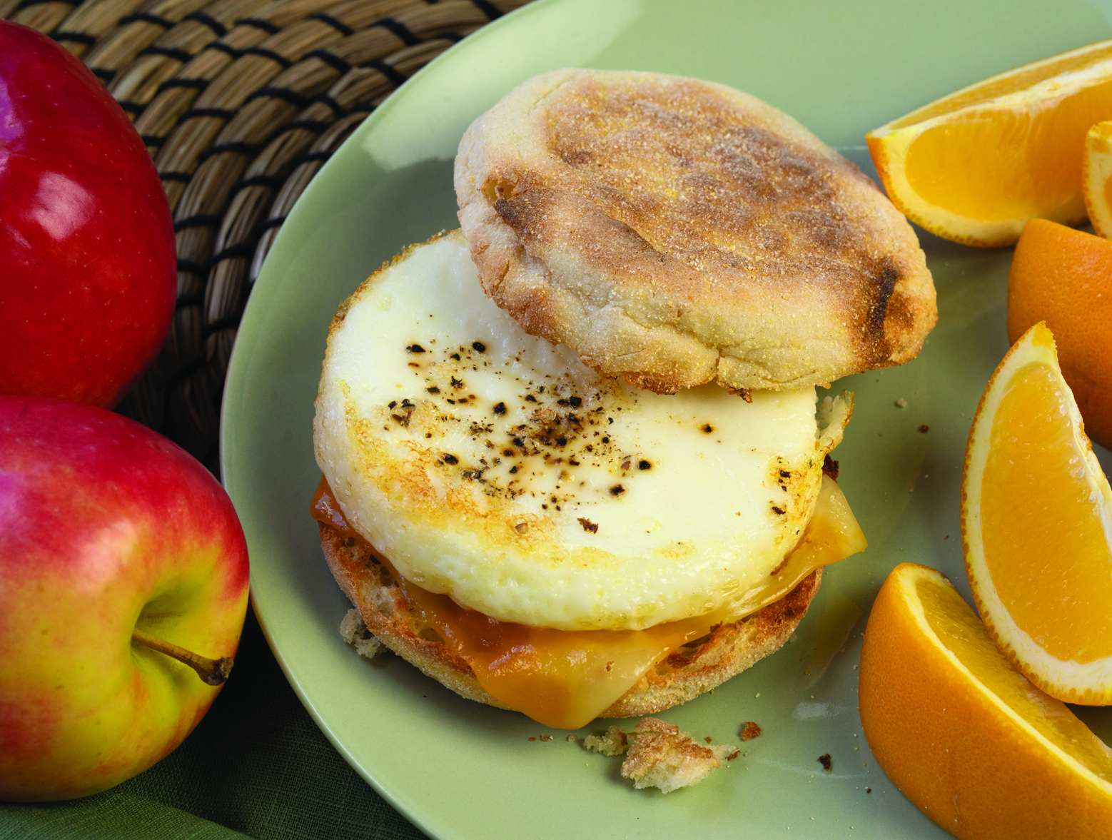 Easy make ahead English muffin breakfast sandwich with apples and orange slices