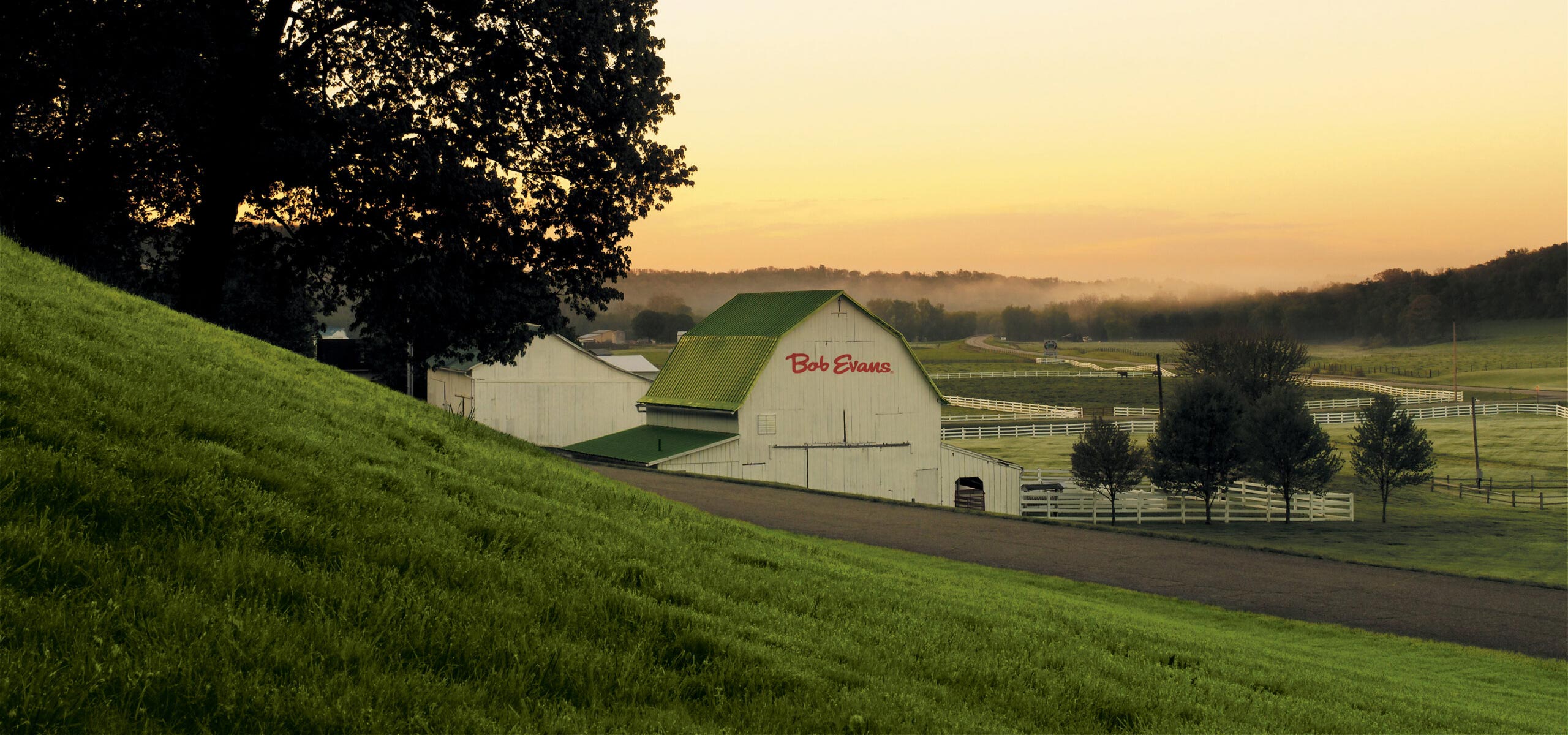 Photo of farm with a barn with Bob Evans logo on the side