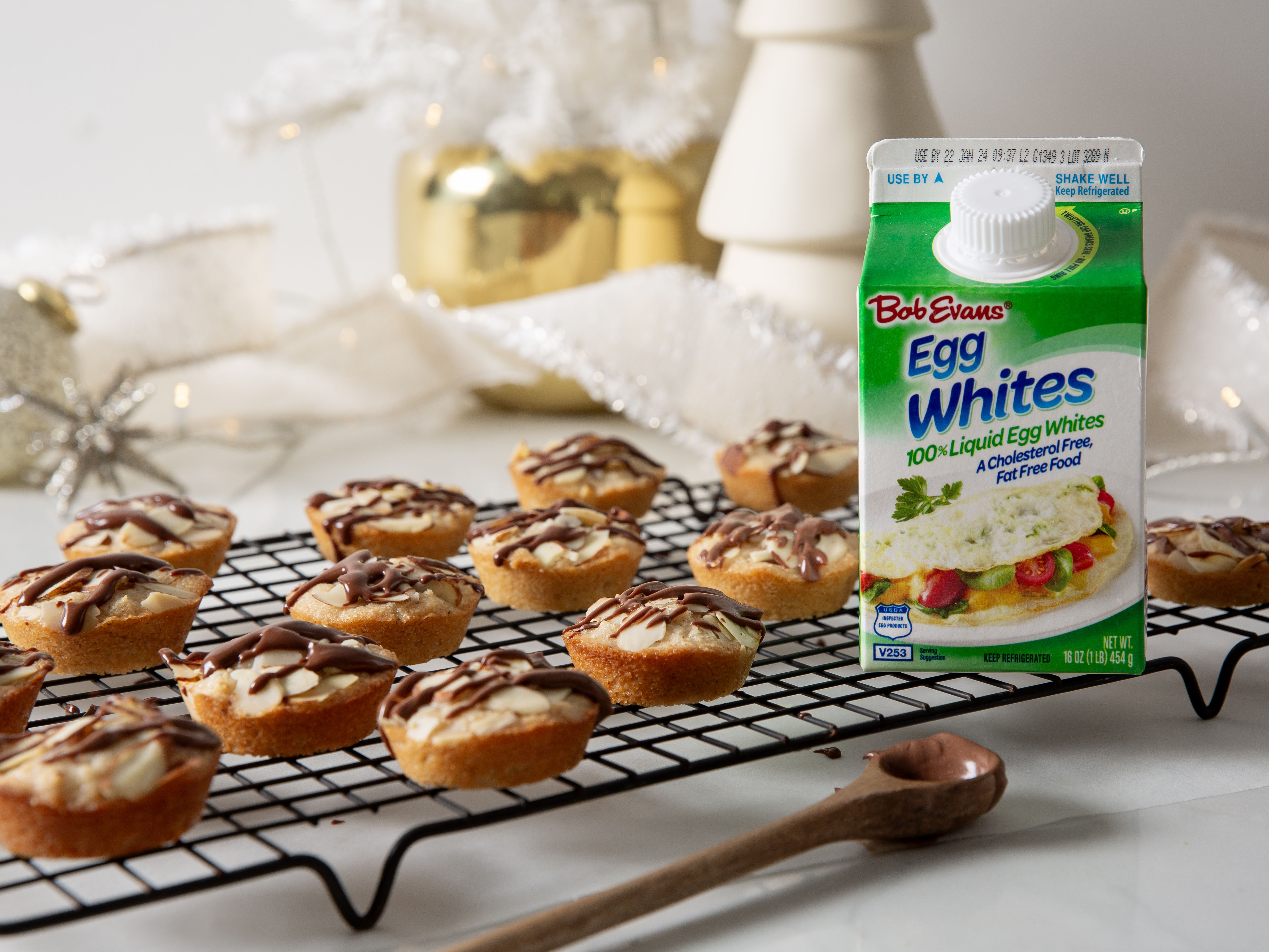 browned butter financiers on a cooling rack next to a carton of Bob Evans 100% Liquid Egg Whites