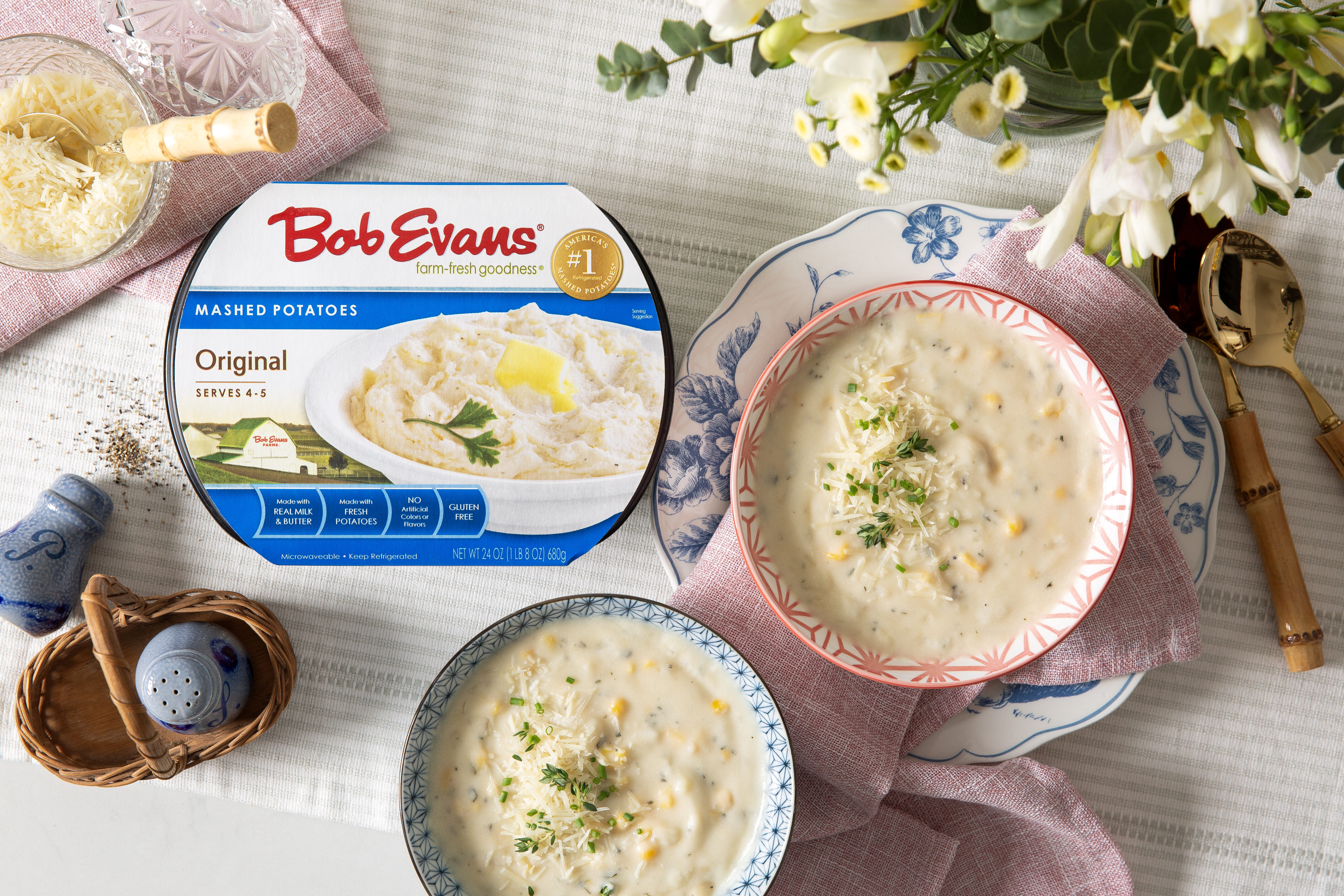 two bowls of potato and corn chowder next to a package of Bob Evans Original Mashed Potatoes