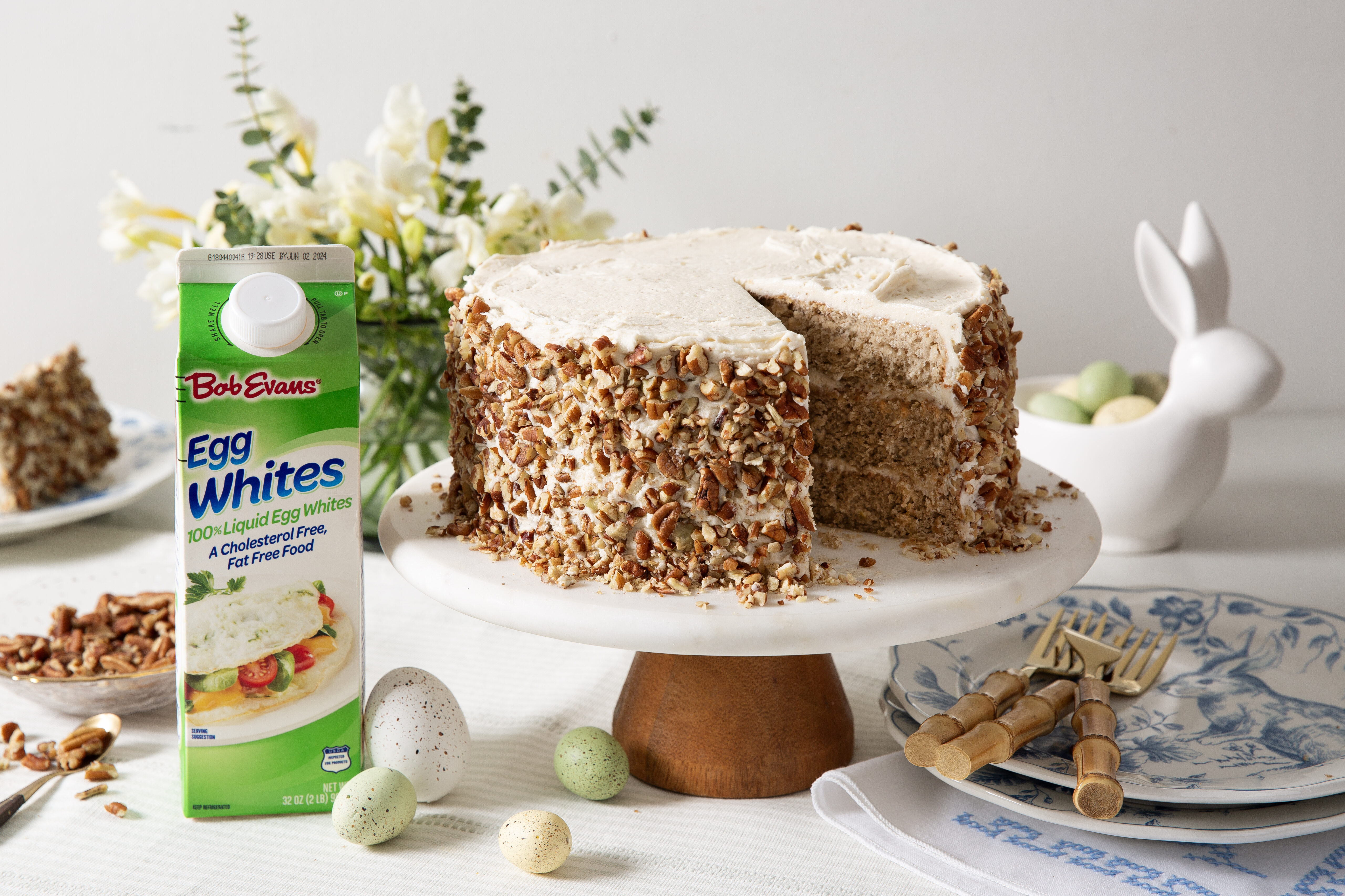 hummingbird cake on a cake stand next to a carton of Bob Evans Liquid Egg Whites