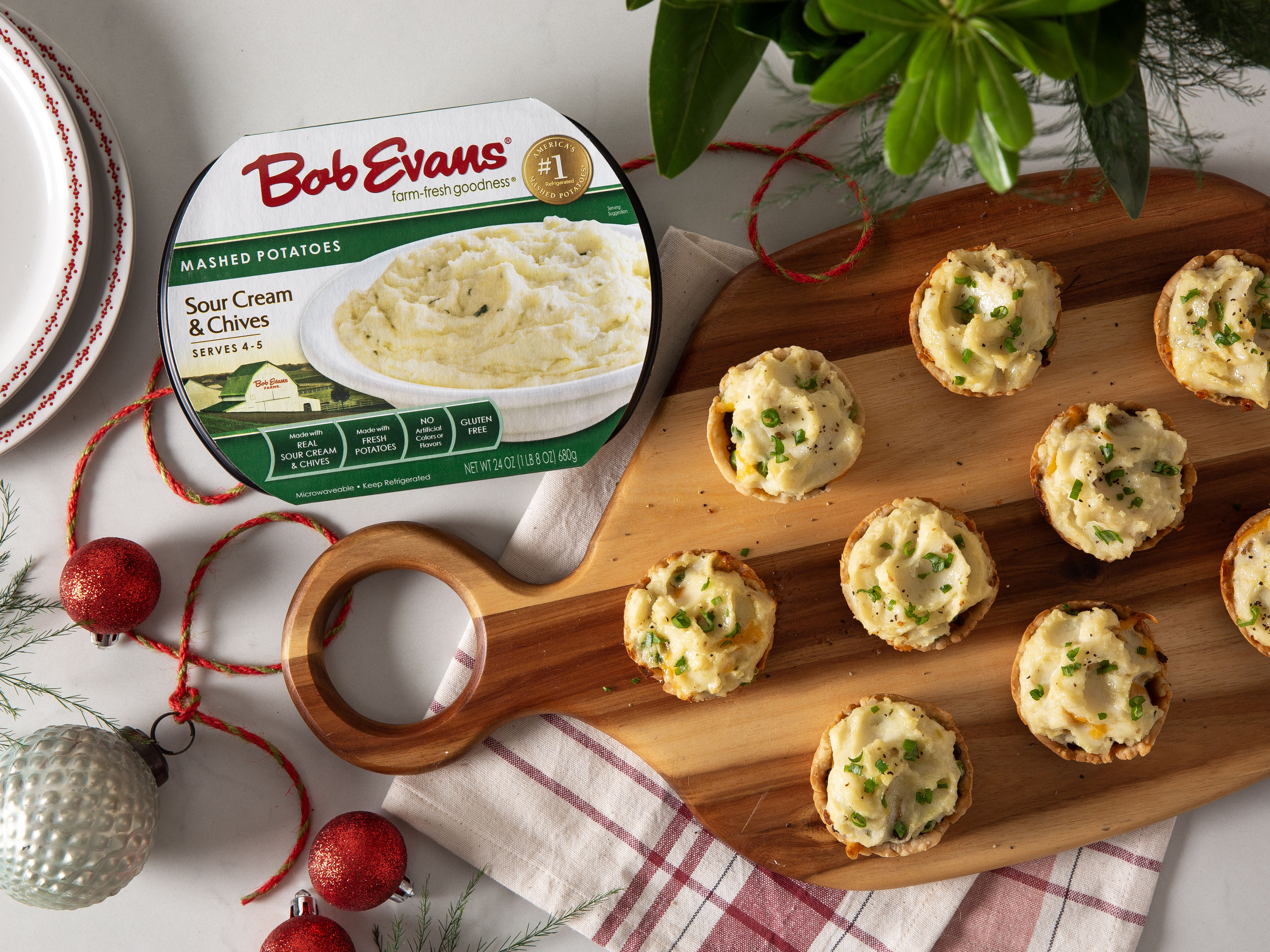 A tray of mini beef pot pies next to Bob Evans Sour Cream & Chives Mashed Potatoes