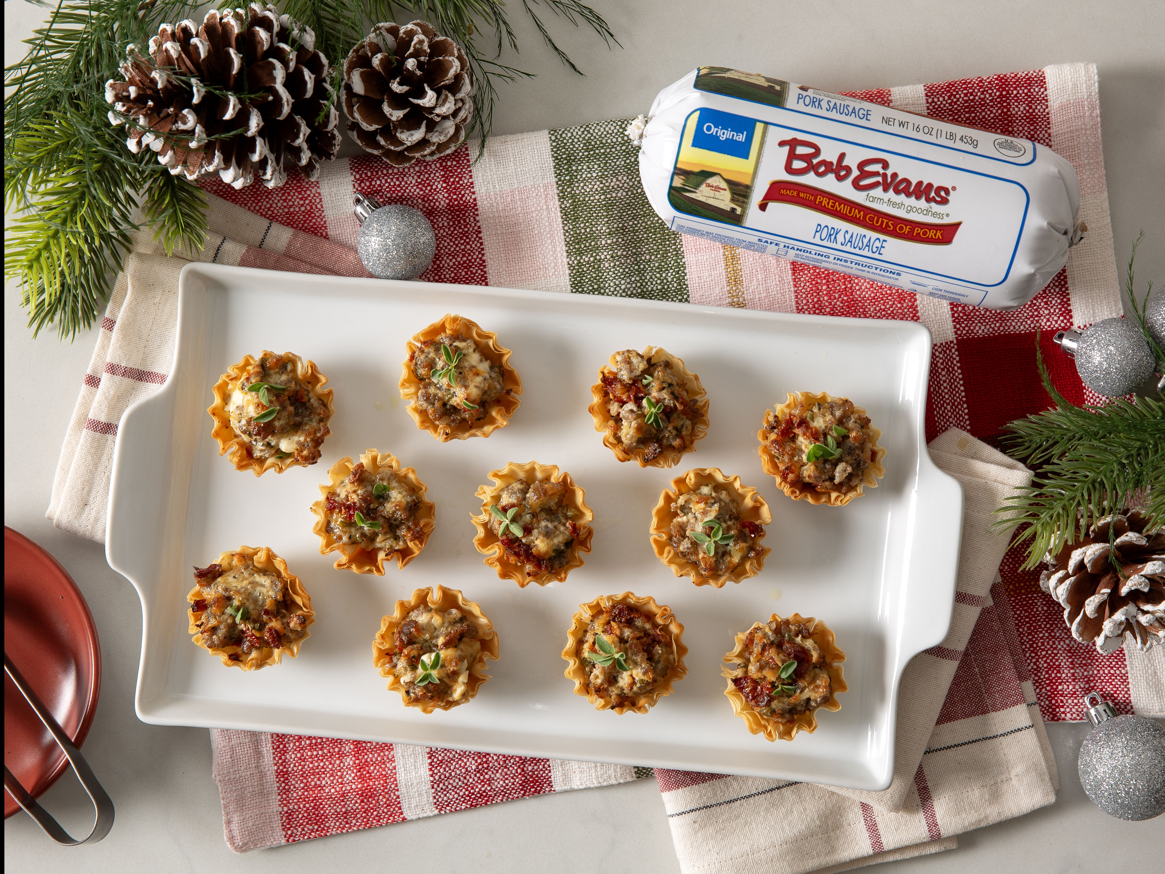 a tray of mini phyllo sausage cups