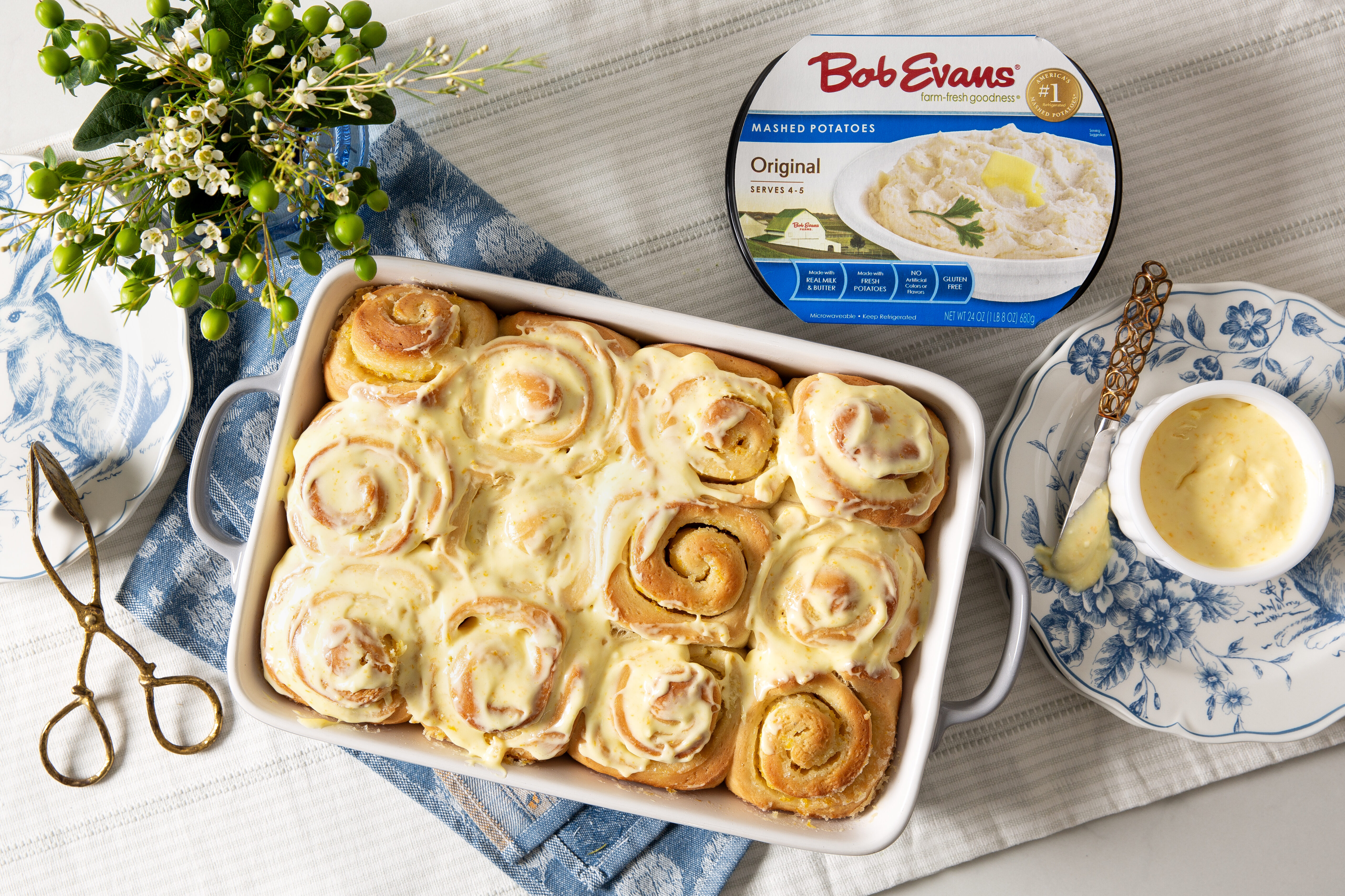 A dish full of orange sweet rolls next to a package of Bob Evans Original Mashed Potatoes