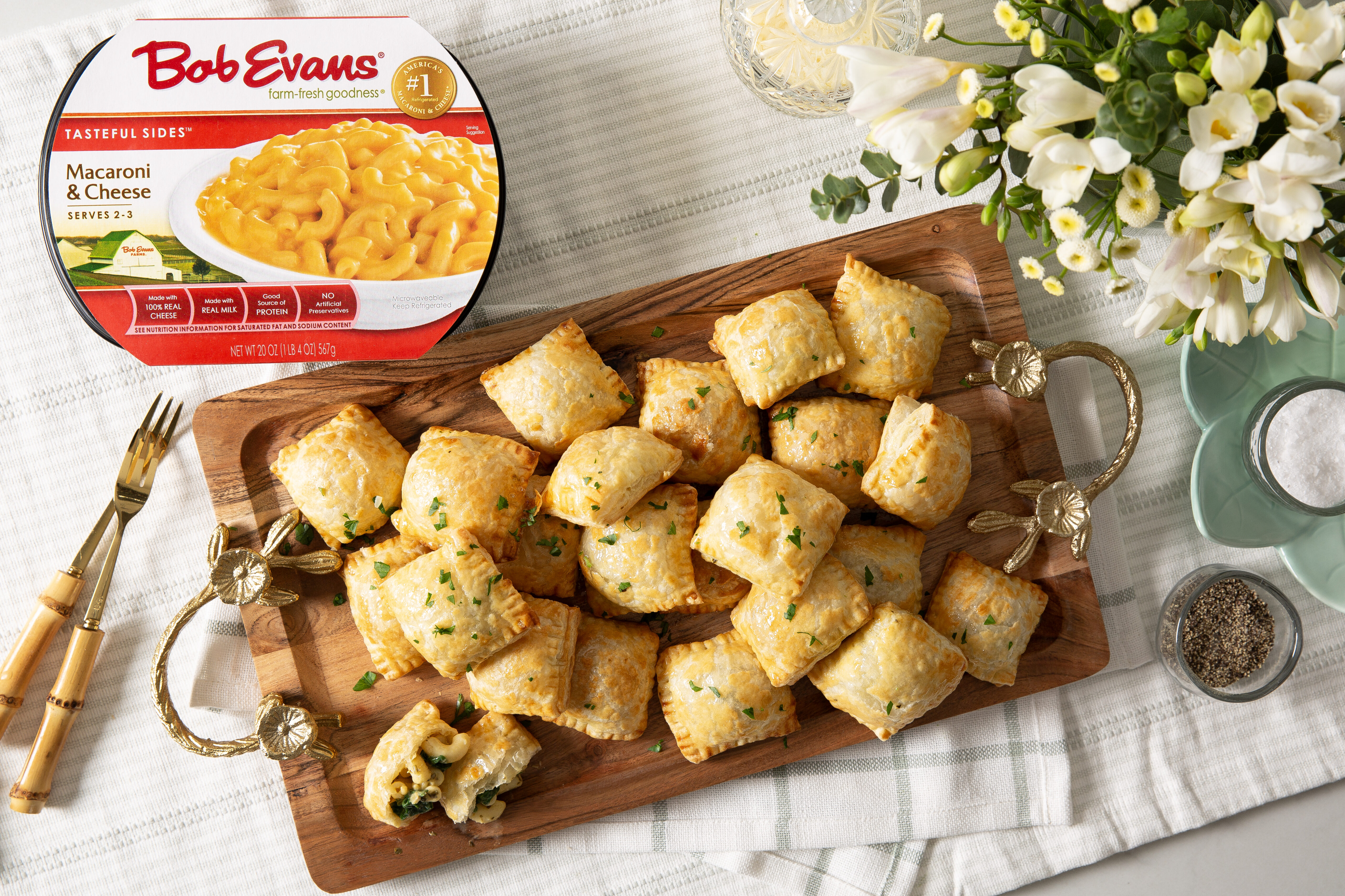 a tray of spinach-pesto macaroni & cheese bites next to a package of Bob Evans Macaroni & Cheese
