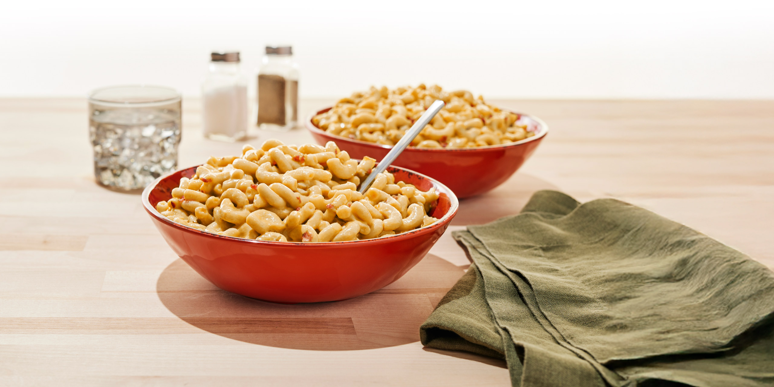 Photo of two bowls on a table filled with Bob Evans Macaroni and Cheese with Bacon